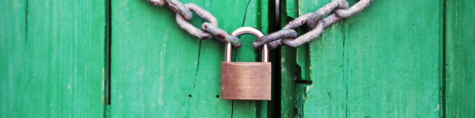 SSL Facts; Padlock connecting two chains in front of green stained wood planks