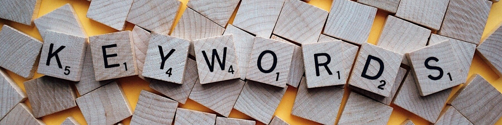 scrabble tiles spelling the word 'keyword;